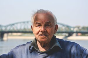 senior man in front of bridge