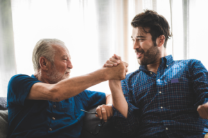 adult son helping older dad