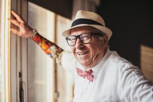 Senior man with tattoo smiling and looking at camera