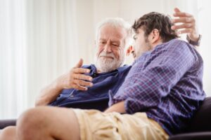 Elderly father and son talking.