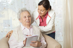 caregiver talking with elderly woman
